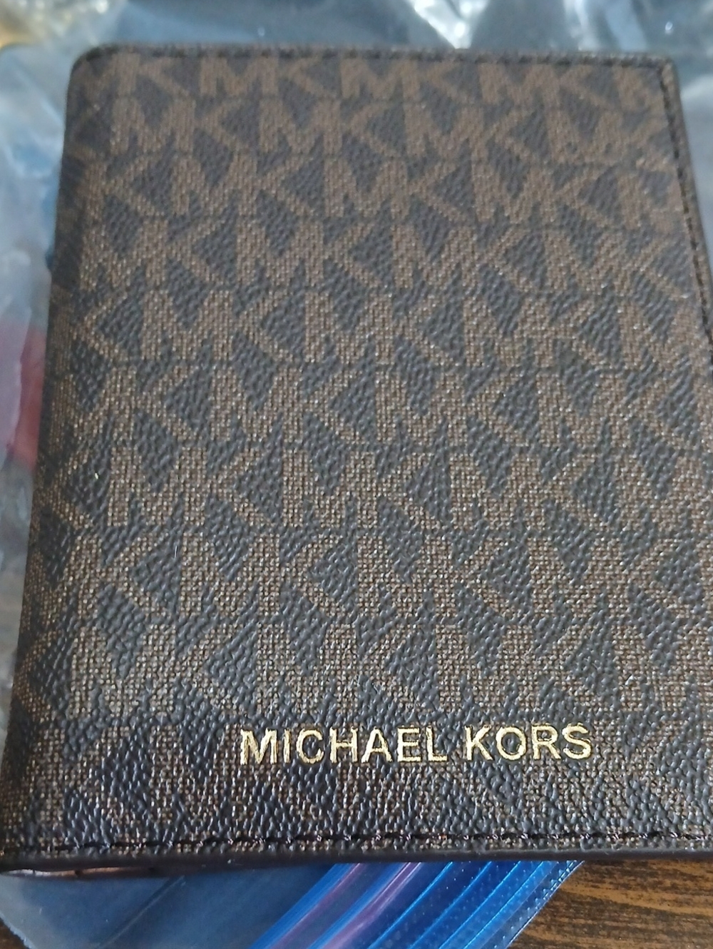 Michael Kors Brown Monogram Passport Holder with Gold Logo